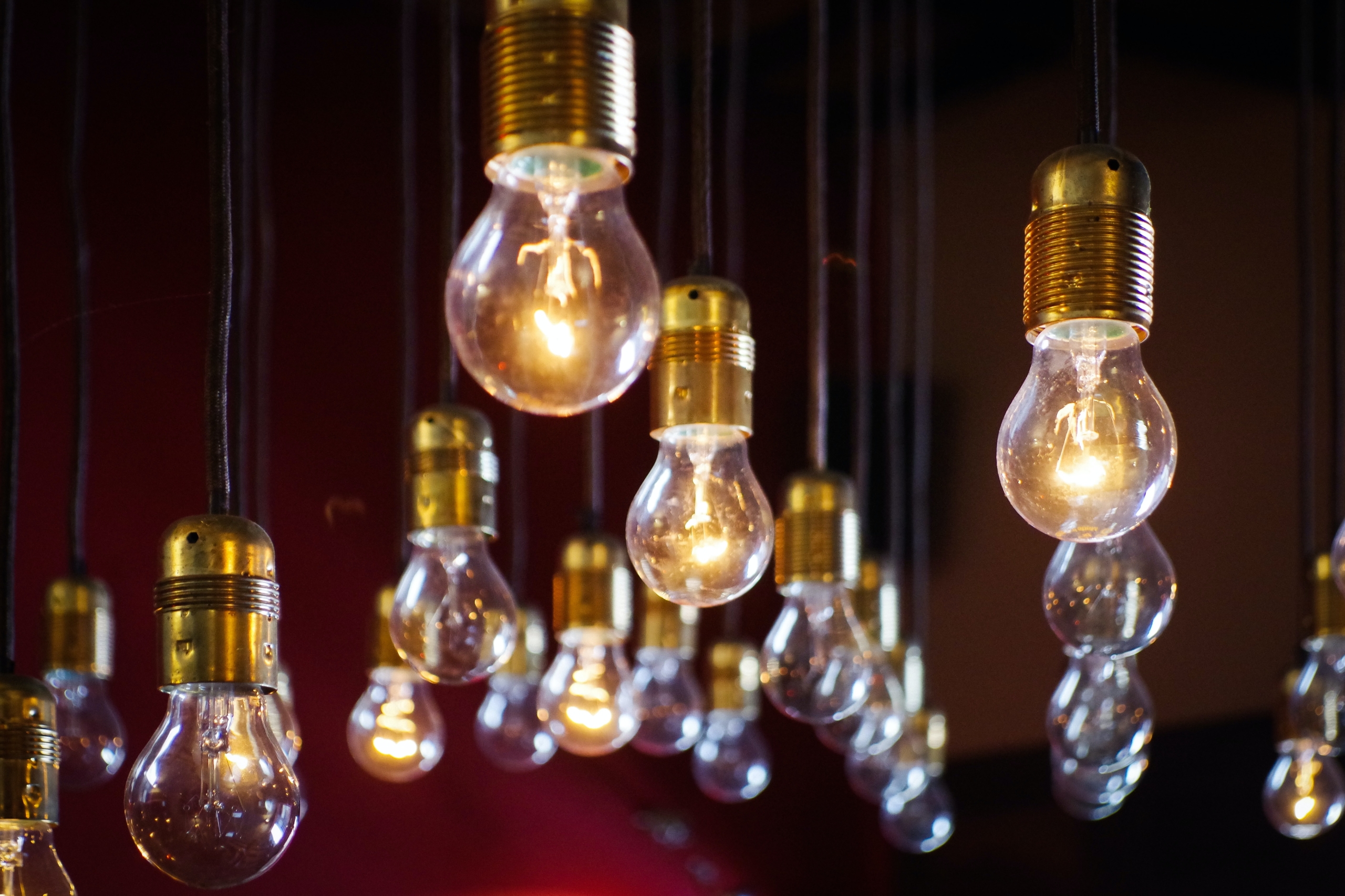 A cluster of hanging lightbulbs, all of them on because the writer on/off switch is also on and full of inspiration.