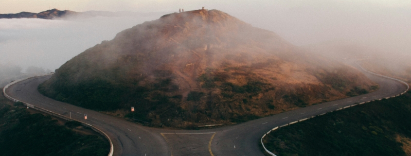 Two roads diverging in front of a mountain that might symbolize a writer accepting defeat and taking a different path to their chosen goal.